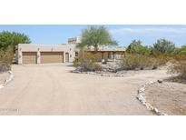 Front view of a stucco home with a two-car garage and desert landscaping at 19927 W Meadowbrook Ave, Litchfield Park, AZ 85340