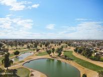 Scenic aerial view of the golf course featuring lush greenery and ponds amidst a neighborhood setting at 4333 N 59 Th Ave, Phoenix, AZ 85033