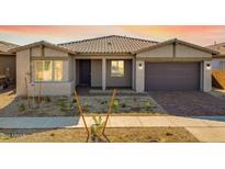 Charming single-story home showcasing a well-kept yard and neutral colored stucco at 14155 W Alameda Rd, Surprise, AZ 85387