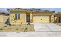 Charming single-story home with a well-manicured gravel front yard and attached two car garage at 24624 W St Catherine Ave, Buckeye, AZ 85326