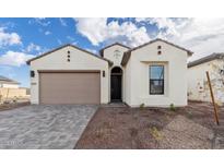 Stunning home featuring a neutral palette, an attached two-car garage, and an easy to maintain xeriscaped front yard at 4359 N 203Rd Ave, Buckeye, AZ 85396