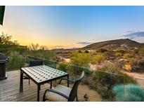 Stunning sunset view from a deck overlooking mountains and desert at 9556 E Celestial Dr, Scottsdale, AZ 85262
