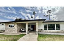 Charming home with a stone facade, covered front porch, and well-manicured lawn at 895 W Tyson St, Chandler, AZ 85225