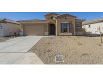 Single-story home with a two-car garage and desert landscaping at 260 S 165Th Ave, Goodyear, AZ 85338