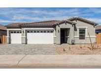 Charming single-story home with a three-car garage, brick accents, and a well-maintained front yard at 11950 W Parkway Ln, Avondale, AZ 85323