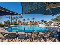 Relaxing pool area with shaded seating and lounge chairs at 16781 S 181St Ln, Goodyear, AZ 85338