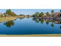 Calm lake reflecting homes and trees; peaceful community view at 16781 S 181St Ln, Goodyear, AZ 85338