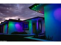 Charming home featuring colorful lights outlining the roofline against a beautiful evening sky at 2236 E Blanche Dr, Phoenix, AZ 85022