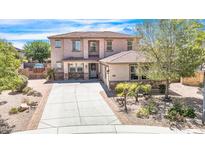 Beautiful two-story home featuring a well-manicured front yard and a long driveway at 9231 W Bent Tree Dr, Peoria, AZ 85383