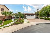 Beautiful home with a two-car garage and landscaped front yard at 10803 E Ramblewood Cir, Mesa, AZ 85212