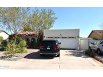 Charming home featuring a well-maintained front yard and two-car garage at 6313 W Onyx Ave, Glendale, AZ 85302