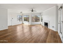 Spacious living room featuring hardwood floors and a fireplace at 7575 E Indian Bend Rd # 2081, Scottsdale, AZ 85250