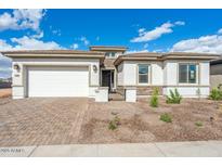 Charming single-story home featuring a brick driveway and a two-car garage at 8746 W Denton Ln, Glendale, AZ 85305