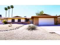 Charming single-story home with desert landscaping, brick accents, and an attached two-car garage at 1531 W Plana Ave, Mesa, AZ 85202