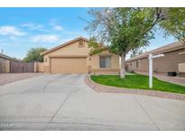 Single-story home with attached garage and landscaped front yard at 14727 N Gil Balcome N Ct, Surprise, AZ 85379