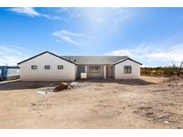 Newly constructed home with a modern design and desert landscape at 22750 E Roper Ln, Florence, AZ 85132