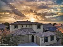 Beautiful two-story home with a two car garage at sunset at 19591 W Lincoln St, Buckeye, AZ 85326