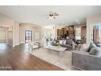 Open-concept living room featuring hardwood floors, neutral paint, modern furniture and gourmet kitchen views at 3518 N Shadow Trl, Mesa, AZ 85207