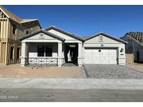 New home exterior with gray siding, brick accents, and a 2-car garage at 1184 E Gleneagle Dr, Chandler, AZ 85249