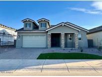 Charming single-story home features a manicured lawn and a two-car garage at 10015 W Verde Ln, Avondale, AZ 85392