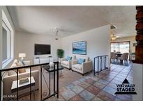 Bright living room features tiled floors, comfy seating, and views to the dining area at 2104 N Olive Ave, Mesa, AZ 85203