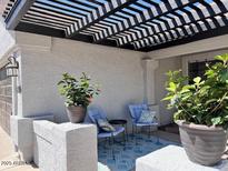 Cozy front porch seating area with lattice-covered patio at 2930 E Leland St, Mesa, AZ 85213