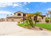Stunning home featuring a three-car garage, beautiful stonework, and desert landscaping at 5312 N Sierra Hermosa Ct, Litchfield Park, AZ 85340