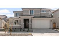 Two-story house with gray exterior, two-car garage, and small front yard at 1449 W Saddle Run, Apache Junction, AZ 85120