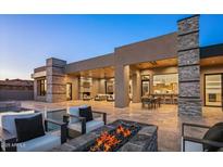 A stunning backyard featuring a pool, fire pit, and seamless indoor-outdoor living with travertine floors at 36323 N 100Th Way, Scottsdale, AZ 85262