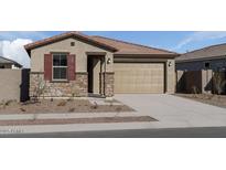 Charming single-story home featuring stone accents and a two-car garage, creating an inviting curb appeal at 18180 W Pima St, Goodyear, AZ 85338