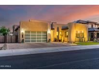 Stunning modern home with a landscaped front yard and large glass garage door at 9503 W Jj Ranch Rd, Peoria, AZ 85383