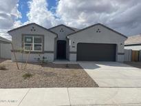 New single-story home with a two-car garage and desert landscaping at 1324 S Mullberry St, Florence, AZ 85132