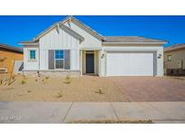 One-story home with white exterior, gray shutters, and a two-car garage at 16430 W Desert Mirage Dr, Surprise, AZ 85388