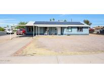 House exterior with solar panels, carport, and landscaped yard at 4833 N 69Th Dr, Phoenix, AZ 85033