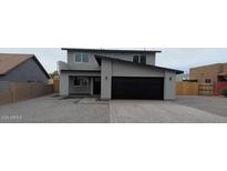 Charming two-story home featuring a modern black garage door and inviting front entrance at 6134 S Borego Rd, Gold Canyon, AZ 85118