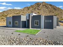 Modern home exterior boasts clean lines and a neutral color palette at 31559 N Pamela Dr, Queen Creek, AZ 85144