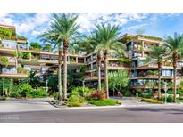 Stunning architecture featuring multi-story balconies with lush greenery and palm trees at 7117 E Rancho Vista Dr # 4006, Scottsdale, AZ 85251