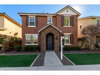 Charming two-story home features a brick-accented entryway and well-maintained lawn at 20747 W Alsap Rd, Buckeye, AZ 85396