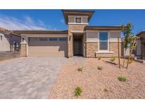 Charming single-story home with a stone facade, brick driveway, and well-maintained landscaping at 31985 N 117Th Ave, Peoria, AZ 85383