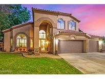 Charming two-story home with a well-manicured lawn, archway and a three car garage at 1201 W Washington Ave, Gilbert, AZ 85233