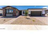 Charming single-story home with a gravel yard, brick accents, and a well-manicured lawn at 1329 W Via De Olivos Dr, San Tan Valley, AZ 85140