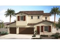 Two-story house with brown roof and shutters, two-car garage, and desert landscaping at 4927 W Cheryl Dr, Glendale, AZ 85302