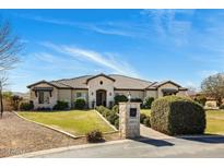 Beautiful single-story home featuring a well-manicured lawn and a charming stone mailbox on a sunny day at 19575 E Vallejo St, Queen Creek, AZ 85142
