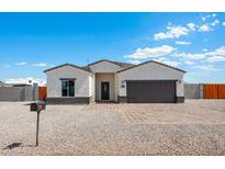 New construction home with a two-car garage and landscaped front yard at 3810 N Mateo Dr, Eloy, AZ 85131