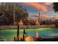 Relaxing pool area with fire bowls at sunset at 40903 N Harbour Town Way, Anthem, AZ 85086