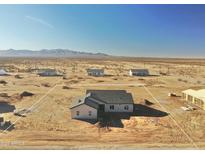 An aerial view of a single-story home with gray roof, located in a desert community of Arizona, USA at 25875 W Running Deer Trl, Wittmann, AZ 85361