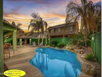 Private backyard pool with mature landscaping and a covered patio, ideal for outdoor entertaining at 4155 E Page Ave, Gilbert, AZ 85234
