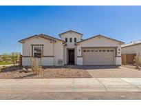 Charming single-story home featuring a brick-paved driveway and a welcoming two-car garage at 11937 W Parkway Ln, Avondale, AZ 85323