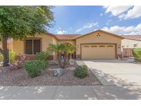 Single-story home with desert landscaping and two-car garage at 18009 W Ivy Ln, Surprise, AZ 85388