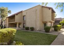 Exterior view of a charming condo with well-manicured landscaping at 8649 E Royal Palm Rd # 131, Scottsdale, AZ 85258